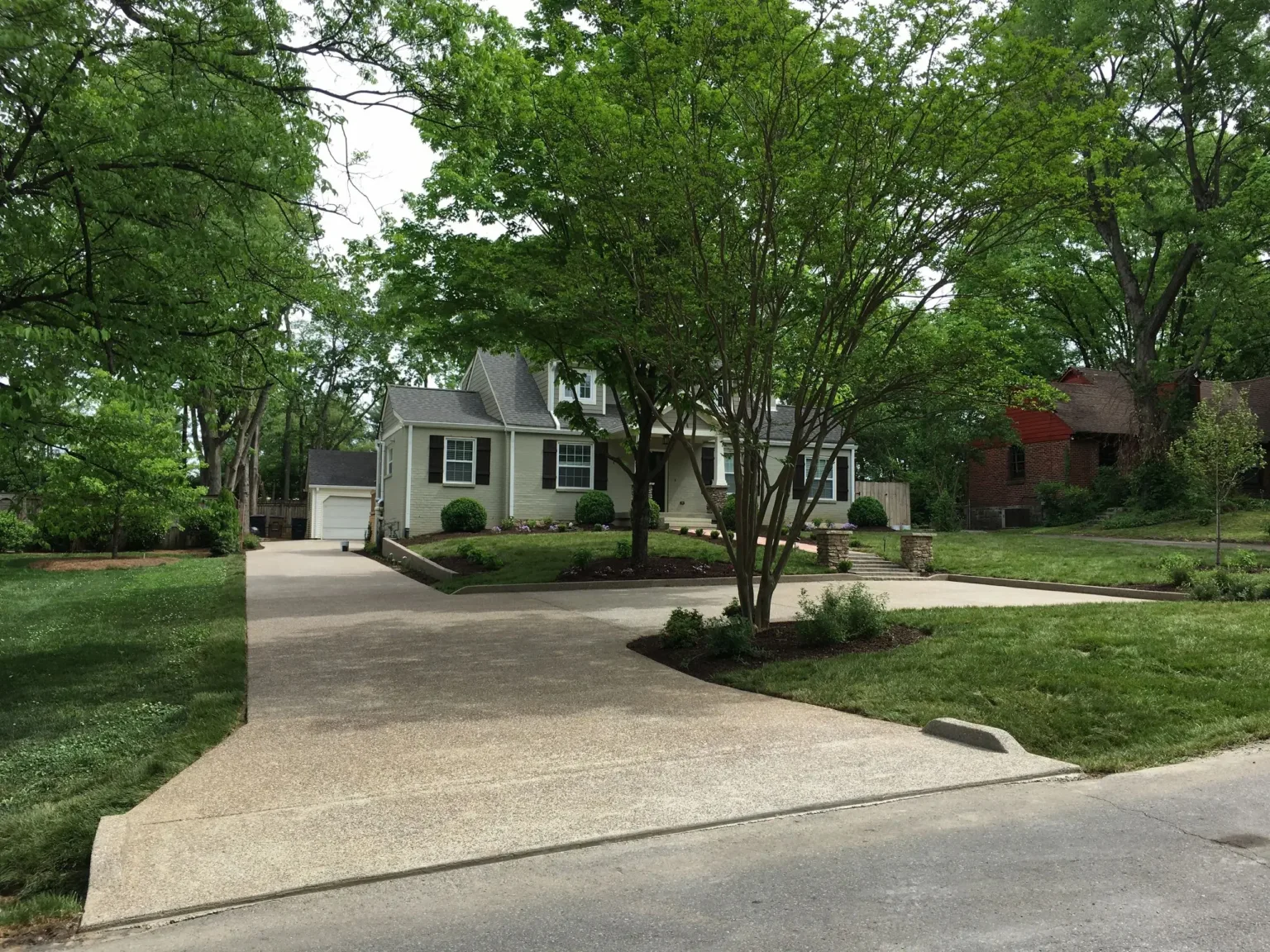 Freshly maintained lawn along a long driveway