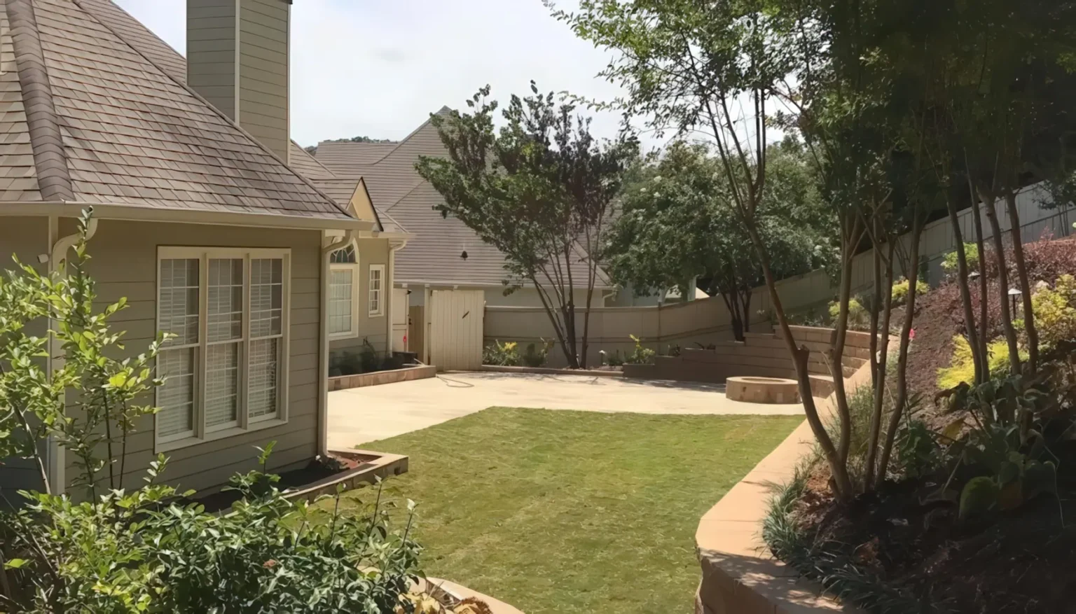 Manicured residential lawn with a curved stone wall